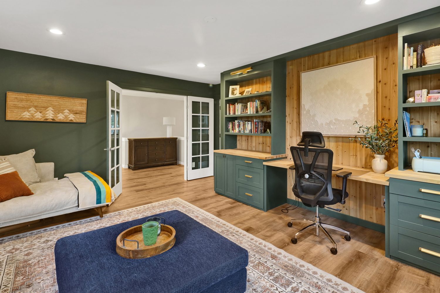 Green office with built-in cabinetry and French doors