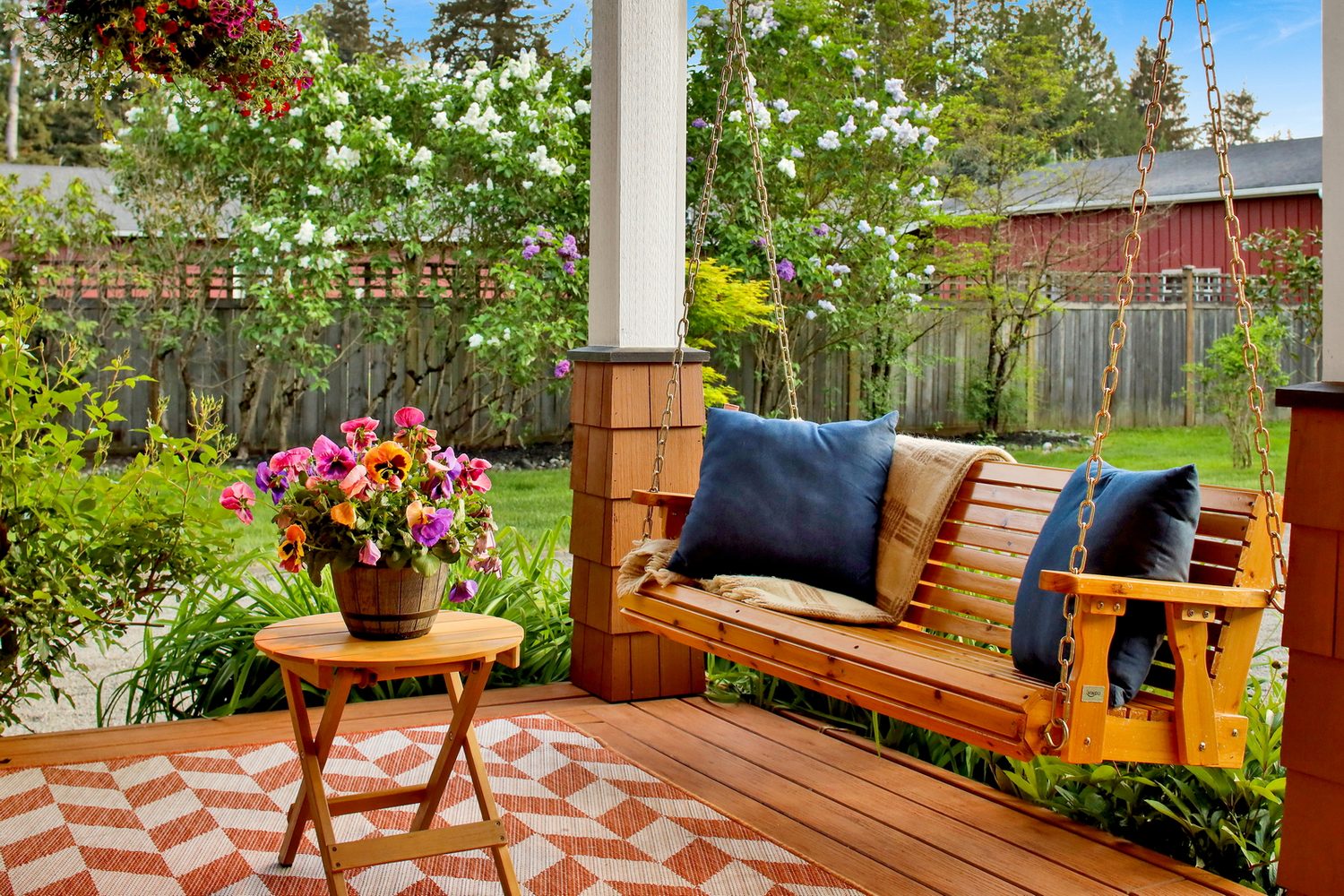 Porch swing surrounded by garden planting at Applegrove
